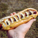 A close-up of a hand holding an Icelanding hot dog
