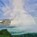 A full rainbow forming over Niagara Falls, from the horseshoe to the American side of the falls.