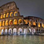 A photo of the Colosseum in Rome all lit up, at night.