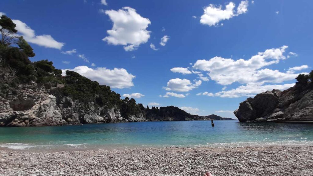 The Bellevue Beach, which is covered with pebbles and sits in a bay, between high cliffs.