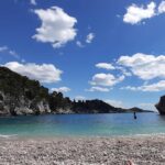 The Bellevue Beach, which is covered with pebbles and sits in a bay, between high cliffs.