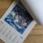 MYPICTURE Review: Bringing My Travel Memories to Life A photo calendar being opened on the April page, which has a photo of snowy Olomouc