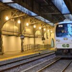 A Go train, which is white and has Go written on the front with green, on the platform, at Union station in Toronto.