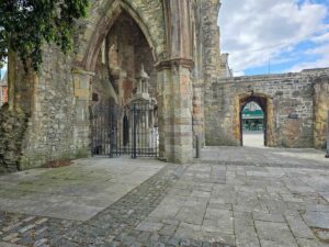 The Titanic memorial fountain, behind a gate, in the left hand side of the ruined church.