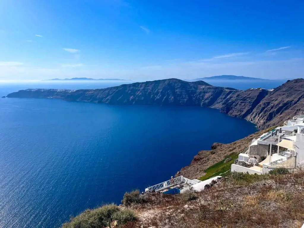 The views from Imerovigli towards the Skaros Rock, which looks like a tail of a dragon over the blue colour of the sea.
