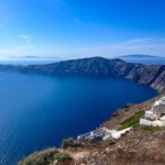 The views from Imerovigli towards the Skaros Rock, which looks like a tail of a dragon over the blue colour of the sea.