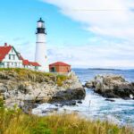 A lighthouse on the rocky shore of the sea.