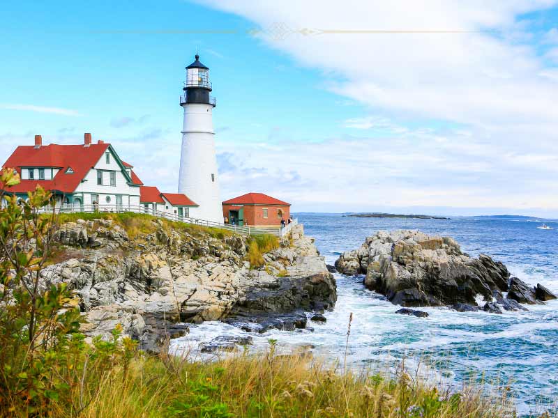 A lighthouse on the rocky shore of the sea.