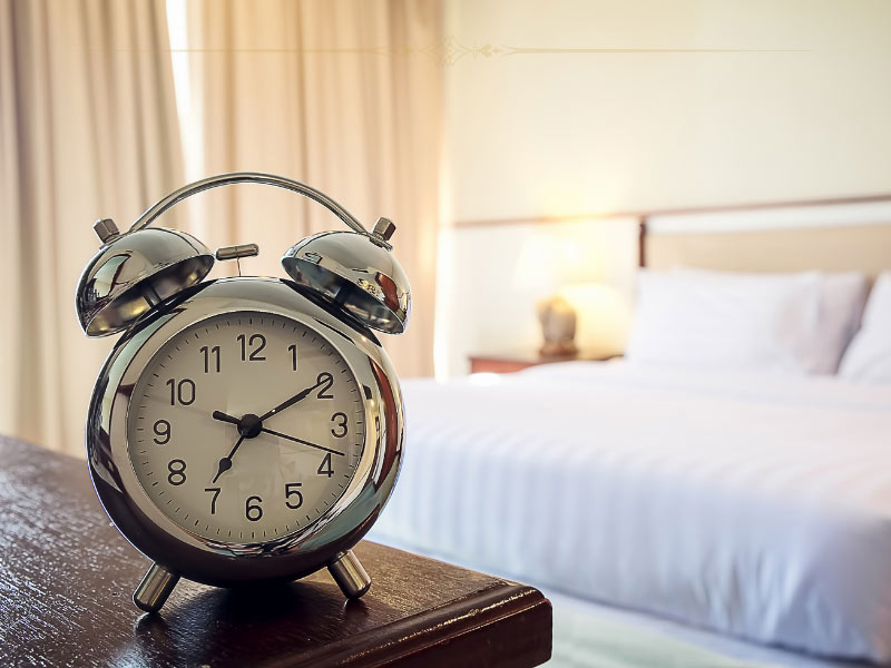 An alarm clock inside a hotel room