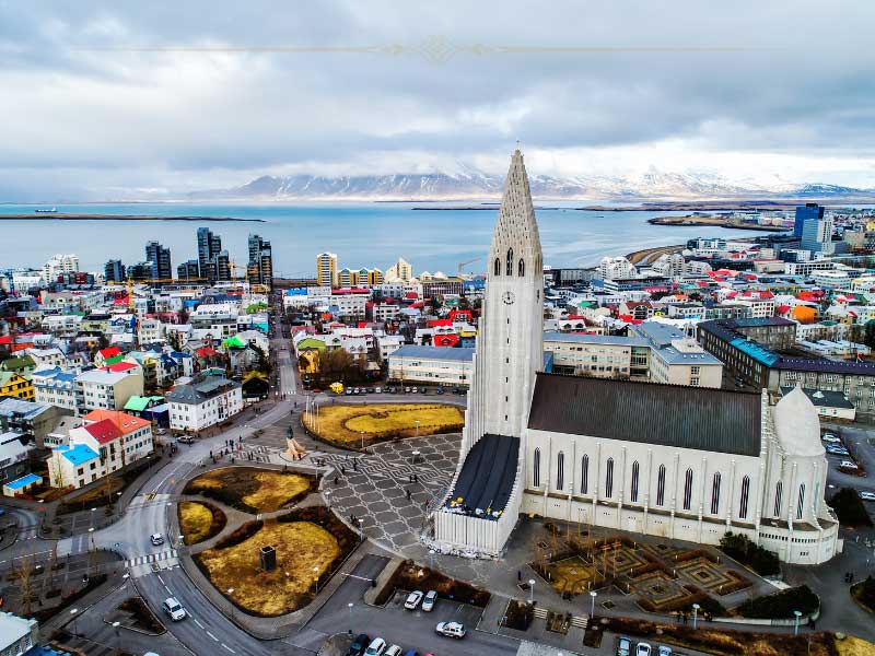 An aerial photo showing the church and the city, which is very small made mostly of houses.