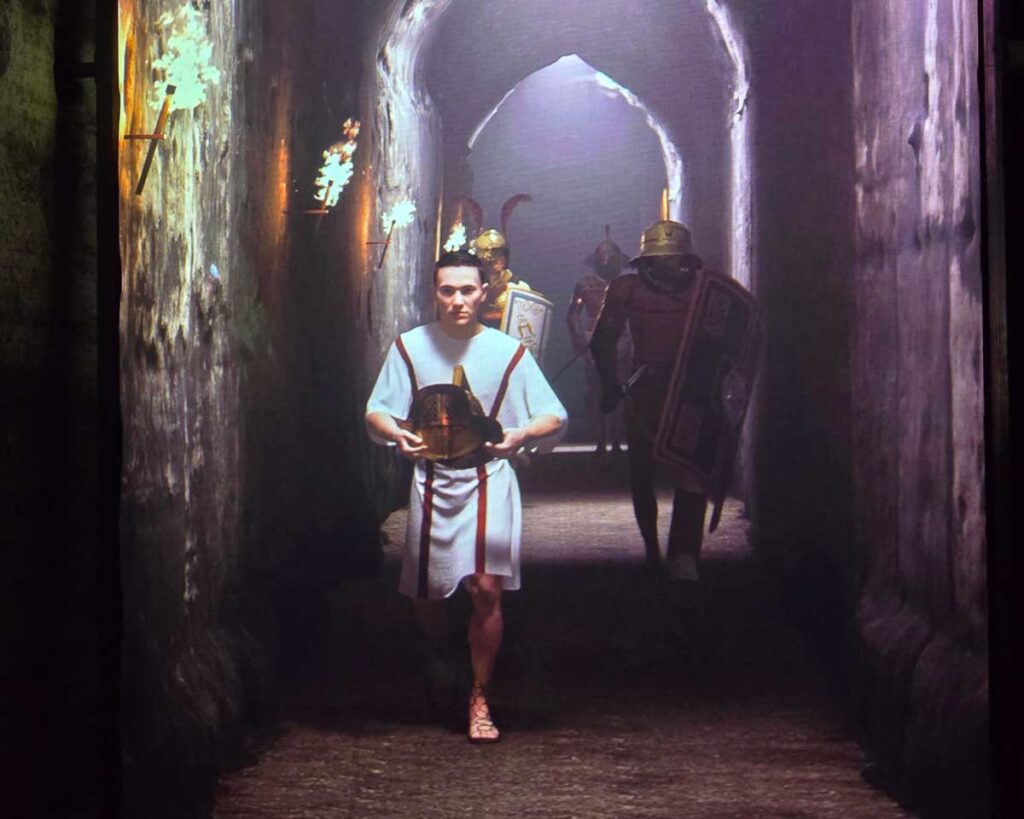 A projection of gladiators coming into the Colosseum, in the underground chambers of the monument