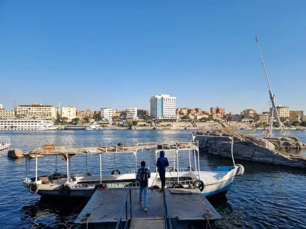 Two men walking towards a public transport ferry in Aswan.