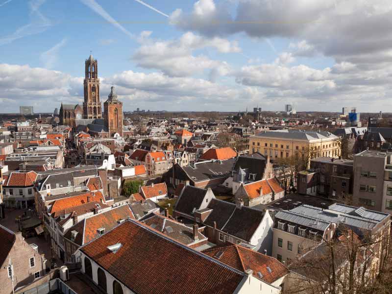 An aerial view of Utrecht, in which you can see the rooftops of the old town as well as the Dom tower
