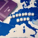 A blue map of Europe with a passport on it and Schengen Area written on it with white cubes