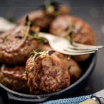 Traditional Danish Foods In Denmark and Where to Find Them in Copenhagen A close-up of a black bowl filled with meatballs