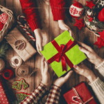 From Pooping Logs to Beach BBQs: A Global Tour of Christmas Traditions A floor filled with presents, and three pairs of hands holding a green box with a red ribbon in their hands.