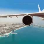 The wing of a plane taking off over Dubai.