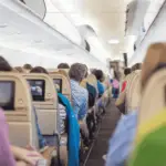 The interior of a plane full with passengers.
