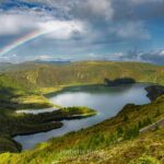 A rainbow over a lagoon inside a caldera.