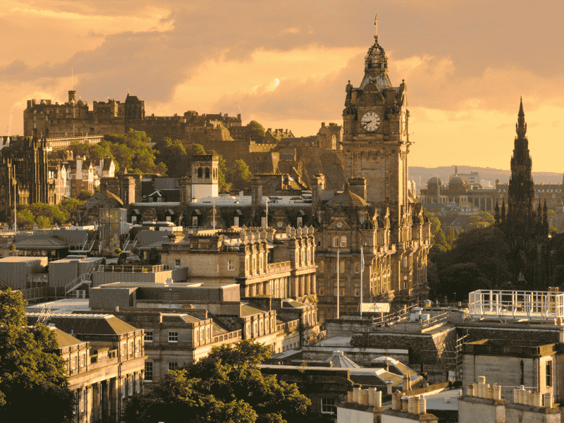 The city of Edinburgh at sunset, with the light reflecting gold into the medieval buildings
