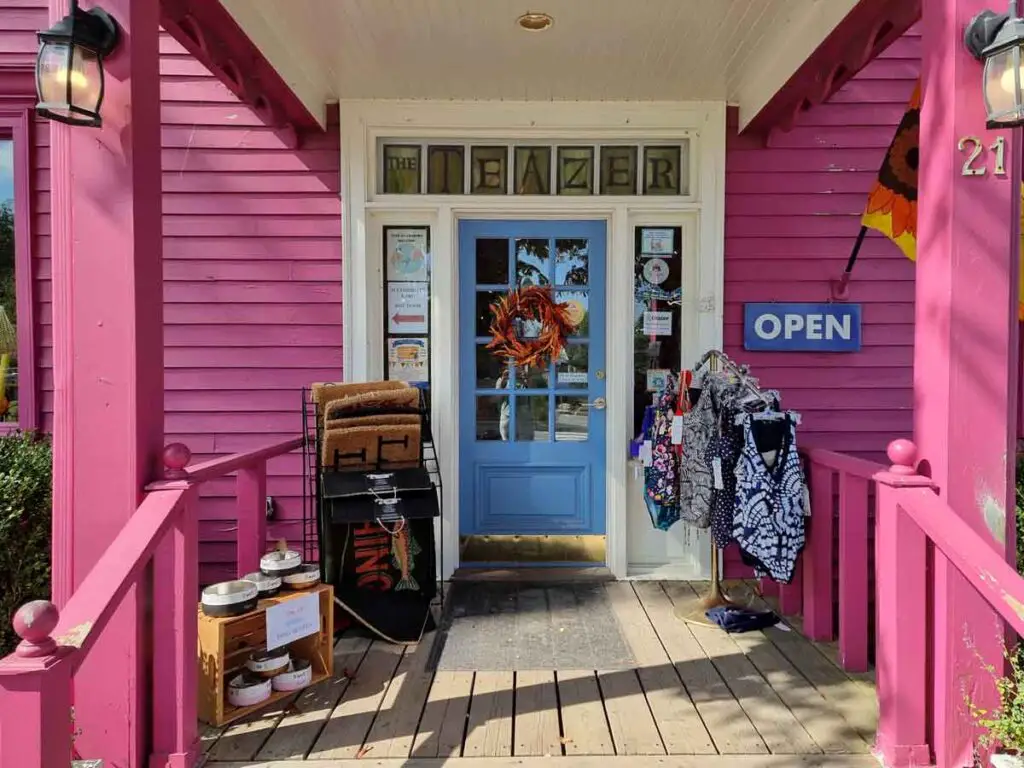 A pink shop with a blue door.