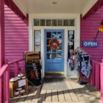 A pink shop with a blue door.