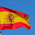 The flag of Spain over a blue sky bakground