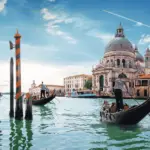 The grand canal in Venice with two gondoliers rowing