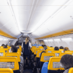 The interior of a plane with yellow chairs