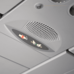 A close-up of the seatbelt sign on, on the plane.