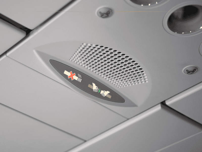 A close-up of the seatbelt sign on, on the plane.