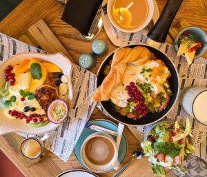 A wooden table with a large breakfast spread