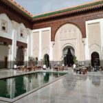 The Oberoi, Marrakesh Review: A Moroccan Palace Reimagined An interior courtyard with a large decor pool, and tables and chairs around it.