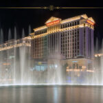 Live Like Royalty in Vegas on a Budget! But Only If You Book Before October 31 Caesars Palace hotel at night, with the fountains on in front of it