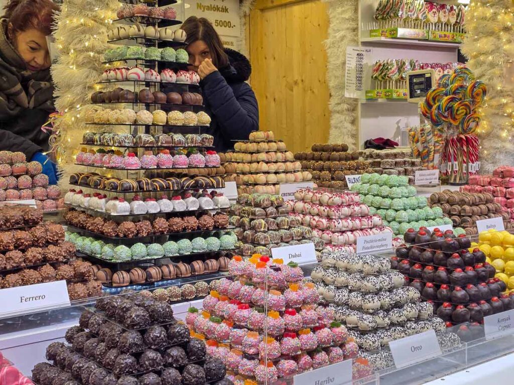 A stall selling bonbons. They are arranged in nice piles, each in a different colour and flavour.