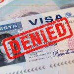 This is How That Rant Tweet From 2020 Could Cancel Your Dream Vacation A visa with a denied stamp on it