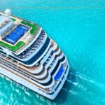 The Best eSIM for Cruise Ships: Why I Used GigSky to Stay Connected on My Last Cruise A cruise ship on azure waters, photographed by drone, from above.
