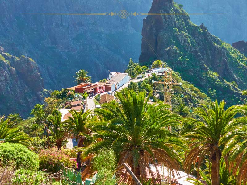A mountain scenery with a small hill top village surrounded by vegetation