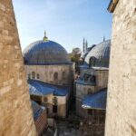 Turkey Travel Guide: Everything You Need to Know Before Your First Visit The blue domes of Hagia Sofia seen between two walls.