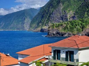 The dramatic coastline of Madeira seen over the rooftops of coastal villas