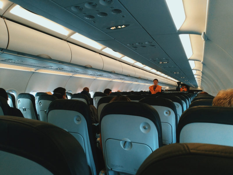 Crew demonstrating the safety procedure on a plane